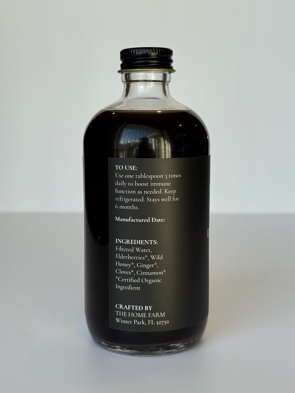 Côté de la bouteille de sirop de sureau avec le mode d'emploi