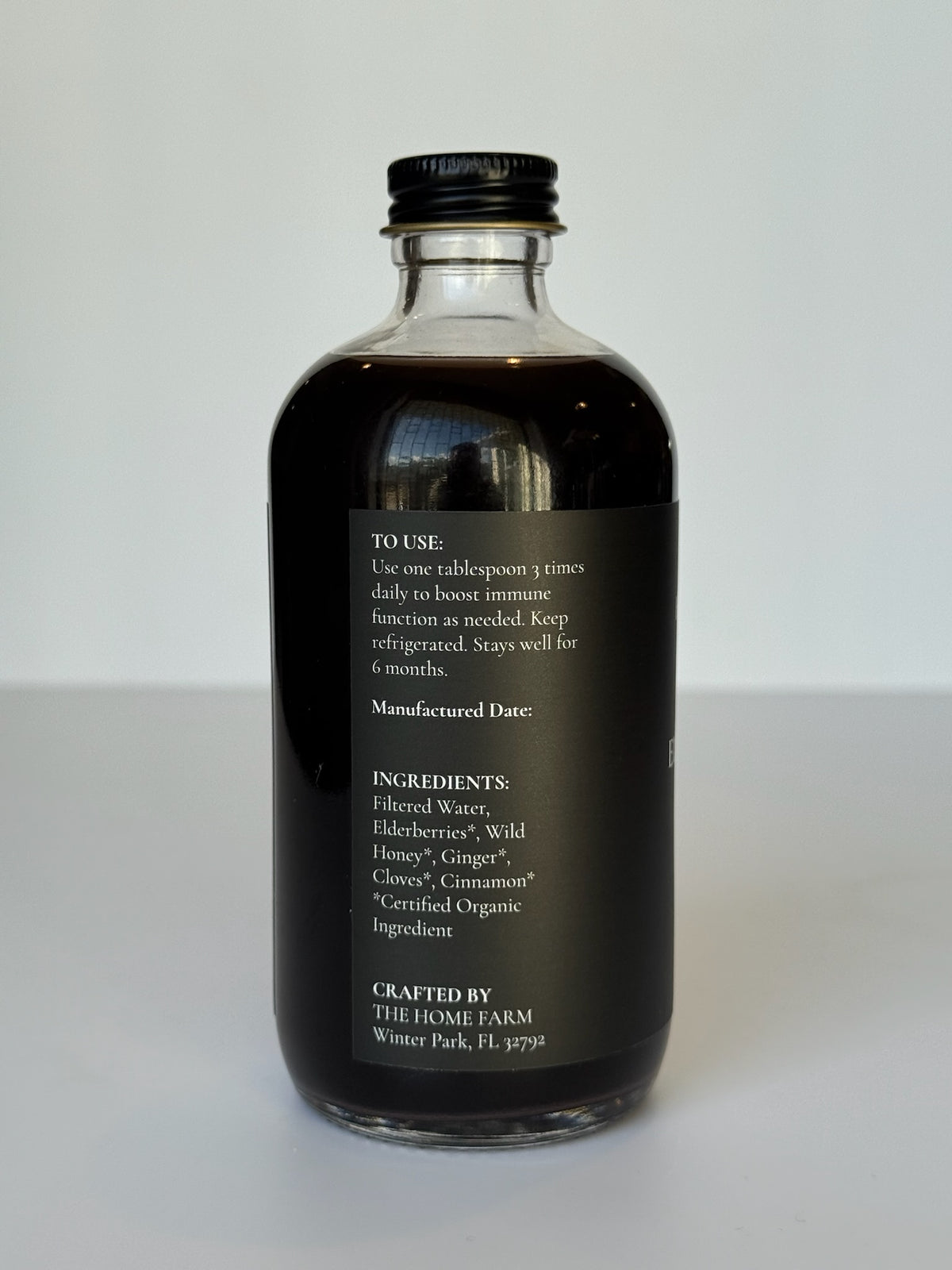 Côté de la bouteille de sirop de sureau avec le mode d'emploi